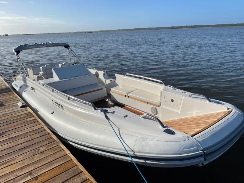 Slide: The Image of 2011 Novurania Chapman Transition 28 boat docked on calm water. - 5