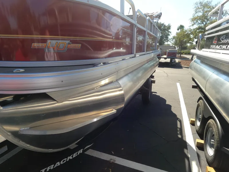 The Image of 2023 Sun Tracker Bass Buggy 18 DLX pontoon boat in parking lot. - 0