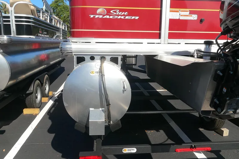 Slide: The Image of 2023 Sun Tracker Bass Buggy 18 DLX pontoon boat rear view in parking lot. - 10