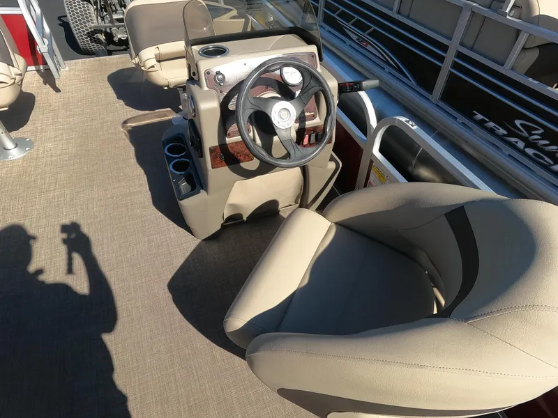 Slide: The Image of 2023 Sun Tracker Bass Buggy 18 DLX boat interior with steering wheel and seating. - 5