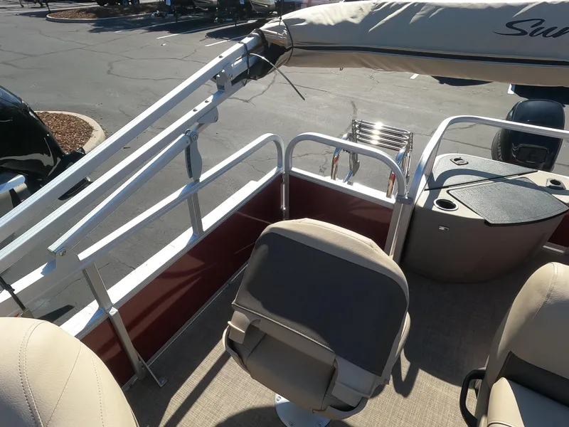 Slide: The Image of 2023 Sun Tracker Bass Buggy 18 DLX pontoon boat interior with seating and railing. - 6