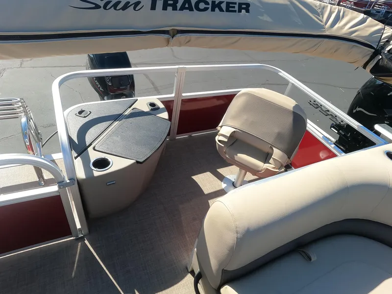 Slide: The Image of 2023 Sun Tracker Bass Buggy 18 DLX pontoon boat interior with seating and storage. - 7