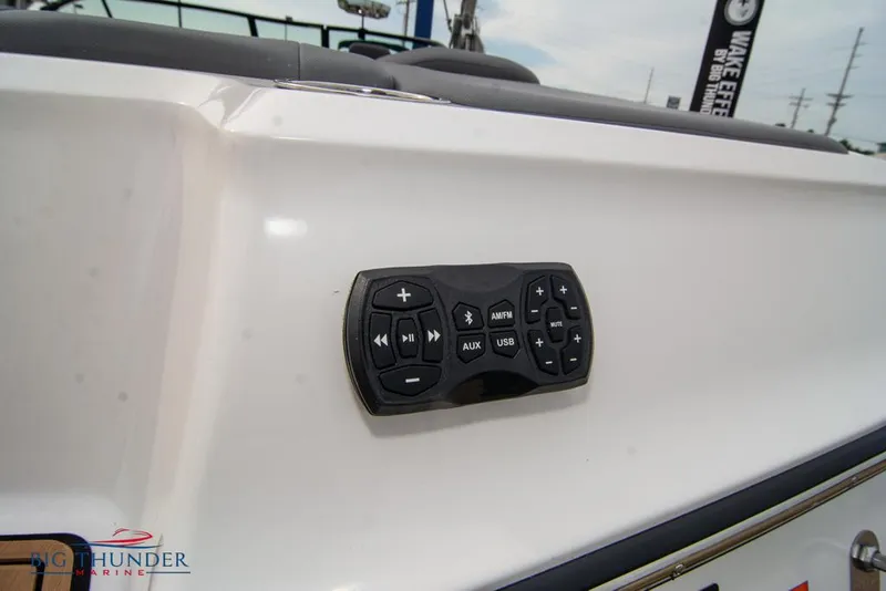 Slide: The Image of 2022 MasterCraft XStar boat audio control panel on white exterior. - 12