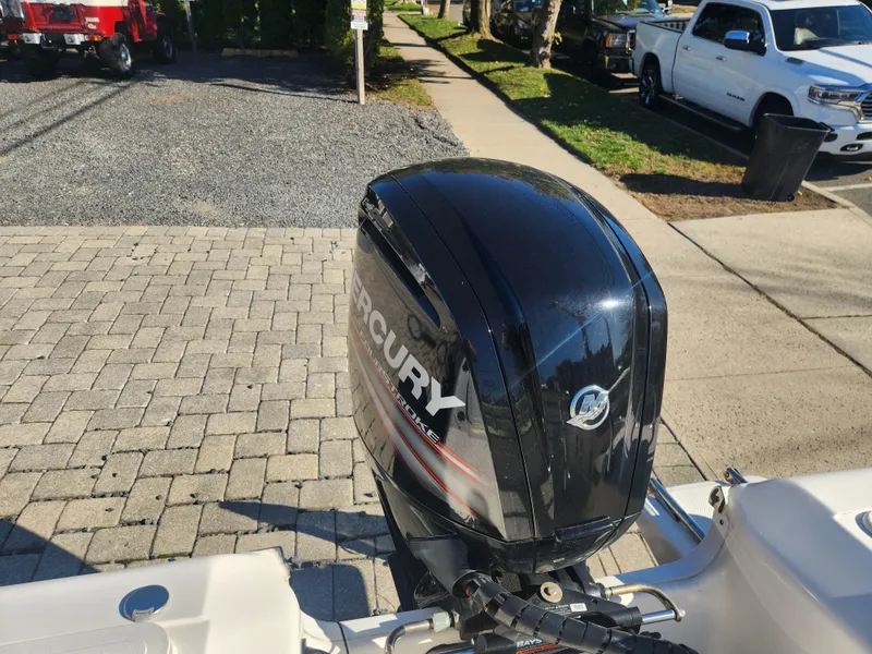 Slide: The Image of 2018 Key West 176 Center Console with Mercury outboard motor in a parking lot. - 3