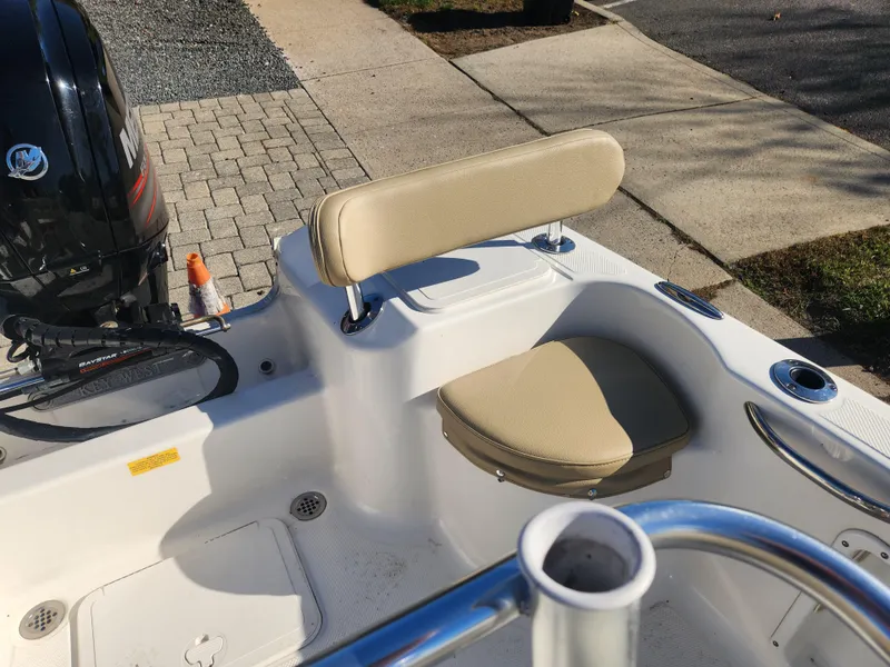 Slide: The Image of 2018 Key West 176 Center Console boat interior with seating and motor. - 5