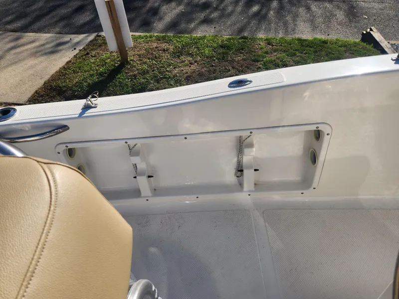 Slide: The Image of 2018 Key West 176 Center Console boat interior with beige seating and white deck. - 6