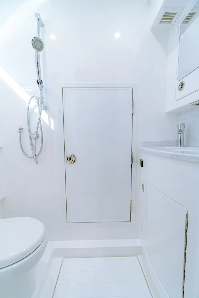 Slide: The Image of 2025 Valhalla Boatworks V-46 bathroom with modern fixtures and sleek white design. - 26