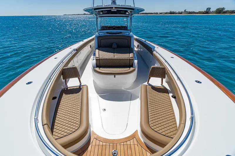 Slide: The Image of 2025 Valhalla Boatworks V-46 luxury boat interior with tan seating on blue ocean. - 31
