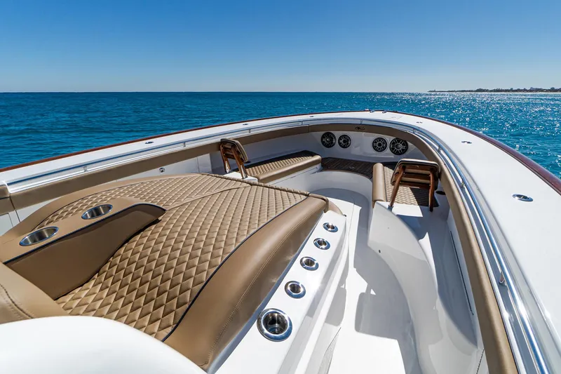 Slide: The Image of 2025 Valhalla Boatworks V-46 luxury deck with ocean view, featuring elegant seating and controls. - 33