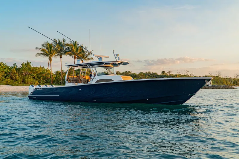 Slide: The Image of 2025 Valhalla Boatworks V-46 cruising near tropical shoreline at sunset. - 7