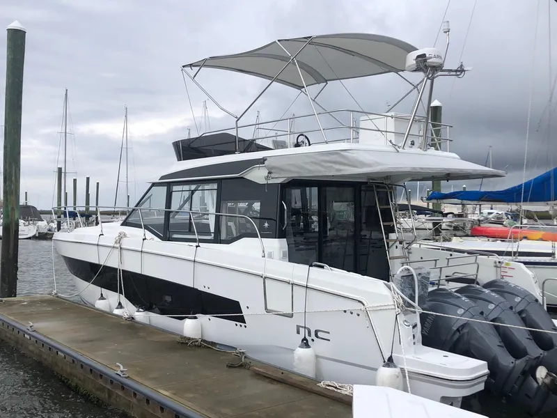 Slide: The Image of 2024 Jeanneau NC 1295 FLY yacht docked at marina. - 1