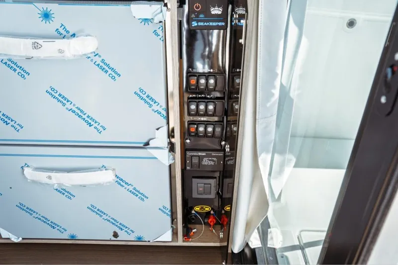 Slide: The Image of Control panel and storage area on 2026 Jeanneau NC 1295 Fly yacht. - 100