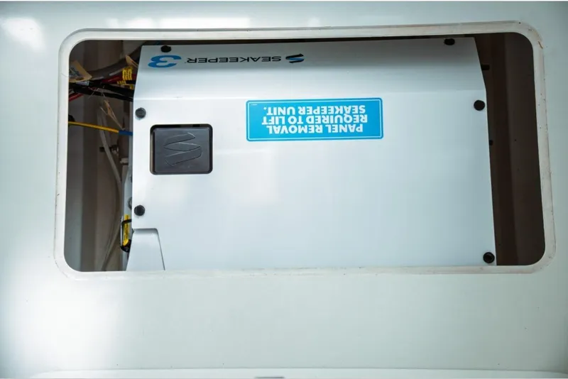 Slide: The Image of Engine compartment of 2026 Jeanneau NC 1295 Fly with Seakeeper unit visible. - 102