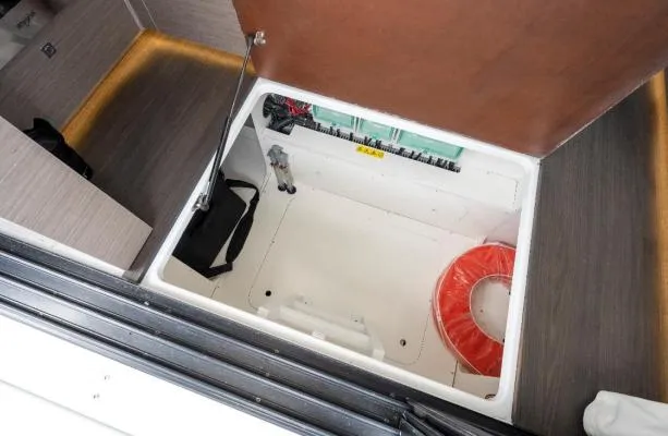 Slide: The Image of 2024 Jeanneau NC 1295 Fly storage compartment with life ring and accessories. - 13