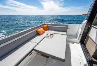 Slide: The Image of 2024 Jeanneau NC 1295 Fly boat deck with seating, ocean view, and sunny sky. - 14
