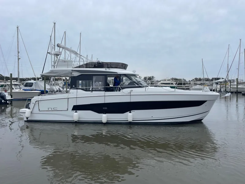 Slide: The Image of 2024 Jeanneau NC 1295 FLY yacht docked in marina. - 22