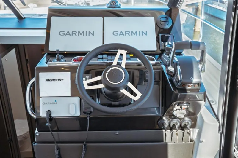 Slide: The Image of Helm of 2026 Jeanneau NC 1295 Fly with Garmin displays and Mercury controls. - 29