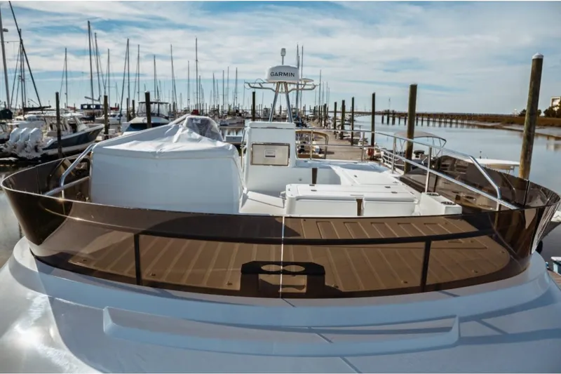 Slide: The Image of 2026 Jeanneau NC 1295 Fly yacht docked at marina, showcasing sleek design and spacious deck. - 33