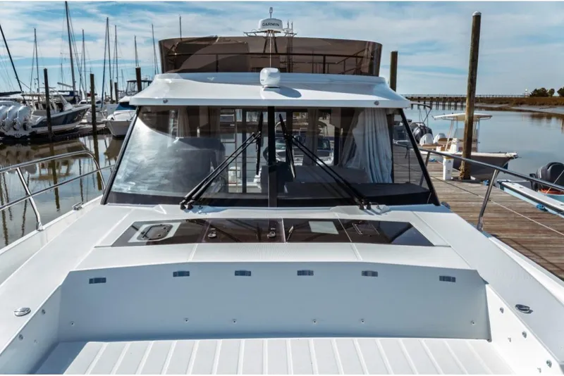 Slide: The Image of 2026 Jeanneau NC 1295 Fly yacht docked at marina, showcasing sleek design and spacious deck. - 35