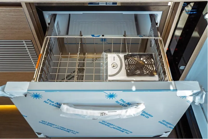 Slide: The Image of Open drawer in Jeanneau NC 1295 Fly 2026 yacht kitchen, showcasing storage space. - 38