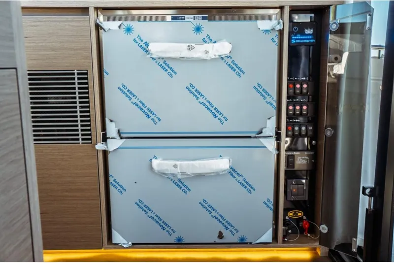 Slide: The Image of 2026 Jeanneau NC 1295 Fly yacht interior with control panel and storage compartments. - 39