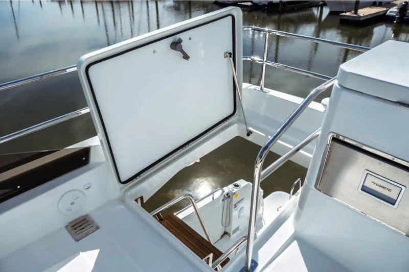 Slide: The Image of Flybridge view of 2026 Jeanneau NC 1295 Fly yacht with open hatch and railing. - 43