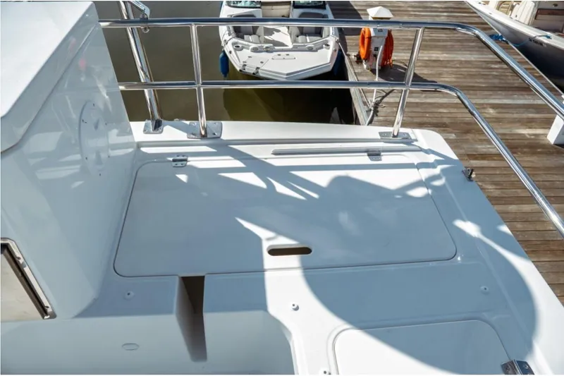 Slide: The Image of 2026 Jeanneau NC 1295 Fly yacht deck with railing, docked at marina. - 44