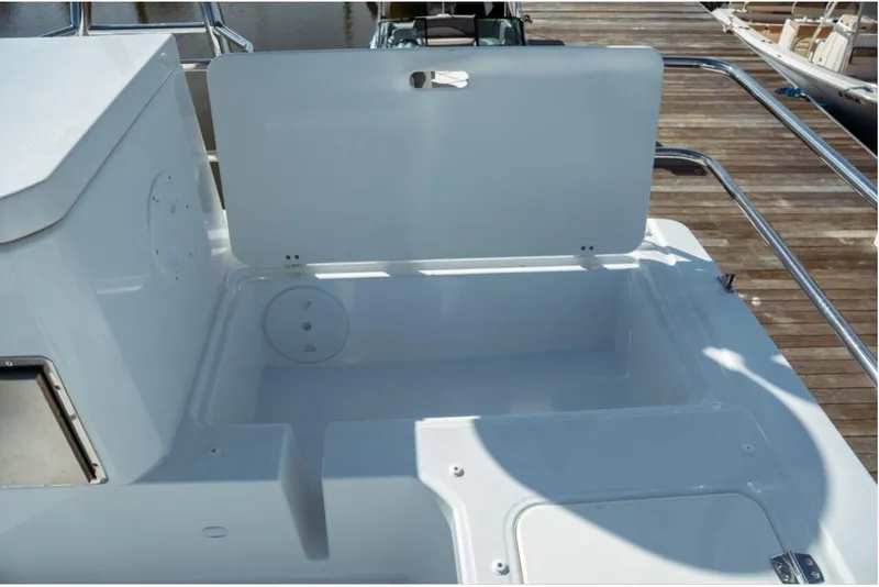 Slide: The Image of Open storage compartment on 2026 Jeanneau NC 1295 Fly boat deck. - 45