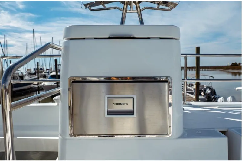 Slide: The Image of 2026 Jeanneau NC 1295 Fly yacht with Dometic appliance, docked at marina. - 48