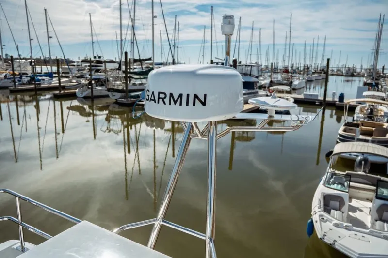 Slide: The Image of 2026 Jeanneau NC 1295 Fly with Garmin radar in a marina setting. - 49