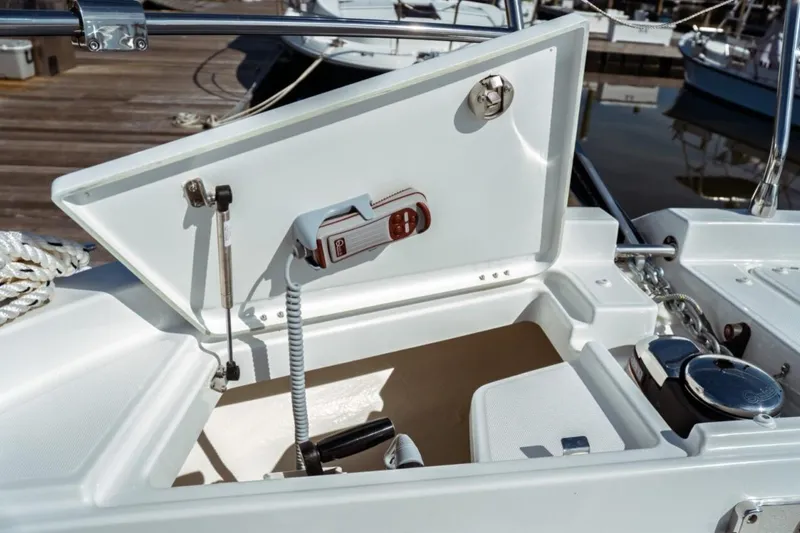 Slide: The Image of Open storage compartment on 2026 Jeanneau NC 1295 Fly boat, docked at marina. - 52