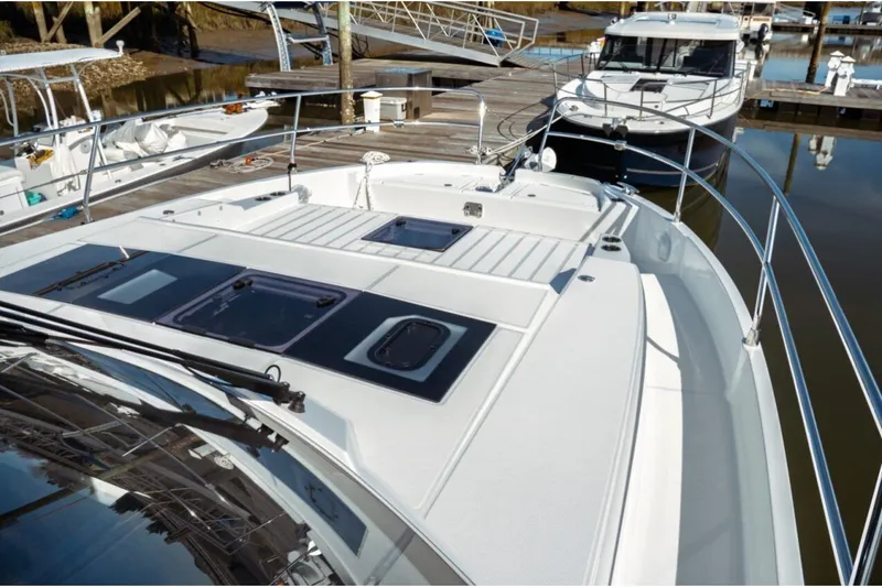 Slide: The Image of 2026 Jeanneau NC 1295 Fly yacht docked, showcasing sleek design and spacious deck layout. - 55