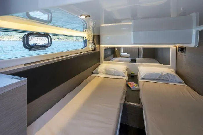 Slide: The Image of 2024 Jeanneau NC 1295 Fly cabin with twin beds and scenic window view. - 7