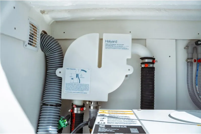 Slide: The Image of Engine compartment of 2026 Jeanneau NC 1295 Fly with Halyard water separator. - 72
