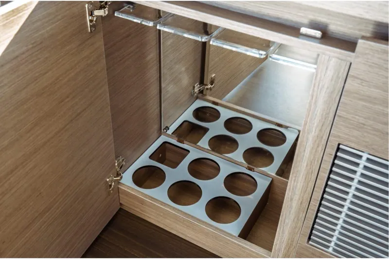 Slide: The Image of Interior storage cabinet with bottle holders on Jeanneau NC 1295 Fly, 2026 model. - 74