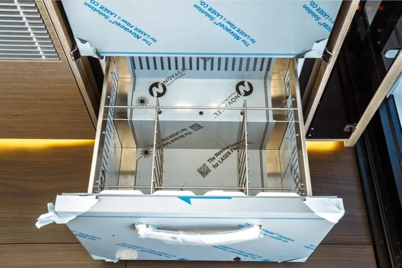 Slide: The Image of Open storage compartment on Jeanneau NC 1295 Fly 2026 yacht, featuring stainless steel interior. - 75