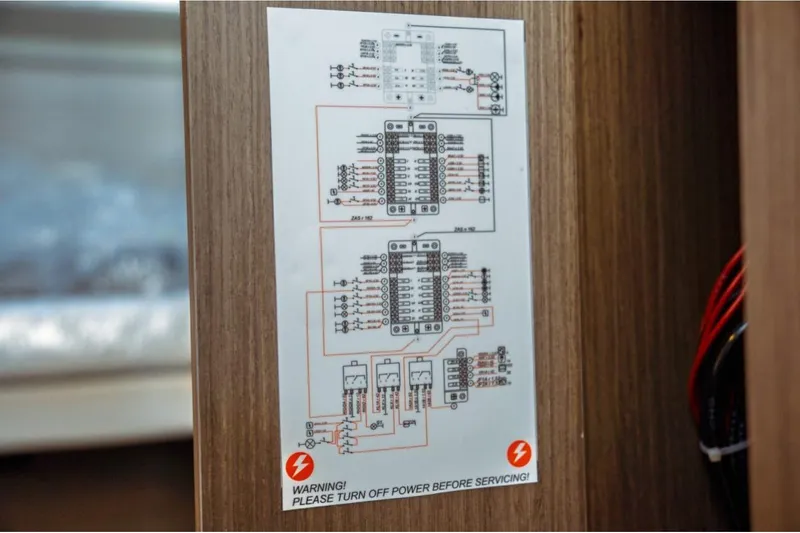 Slide: The Image of Electrical schematic on Jeanneau NC 1295 Fly 2026, warning to turn off power before servicing. - 80