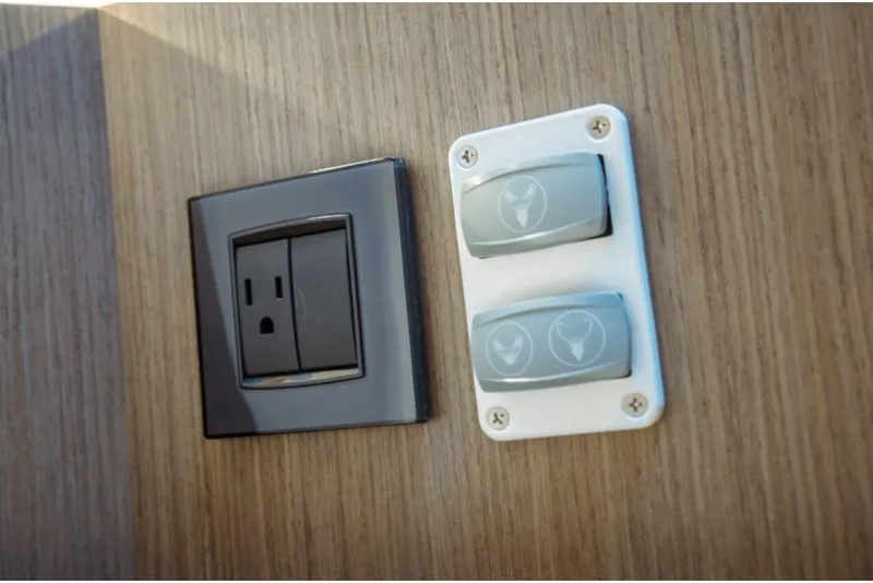 Slide: The Image of Power outlet and switches on Jeanneau NC 1295 Fly 2026 yacht interior. - 86