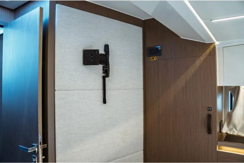 Slide: The Image of Interior view of 2026 Jeanneau NC 1295 Fly, featuring modern wood paneling and wall mount. - 90