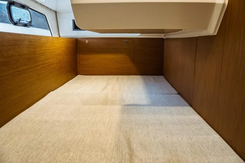 Slide: The Image of Interior cabin of 2026 Jeanneau NC 1295 Fly, featuring wood paneling and a cozy sleeping area. - 96