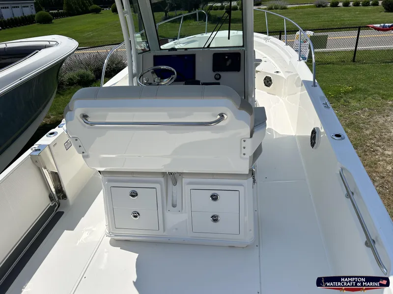 Slide: The Image of 2023 Boston Whaler 280 Dauntless boat interior with helm and storage compartments. - 10