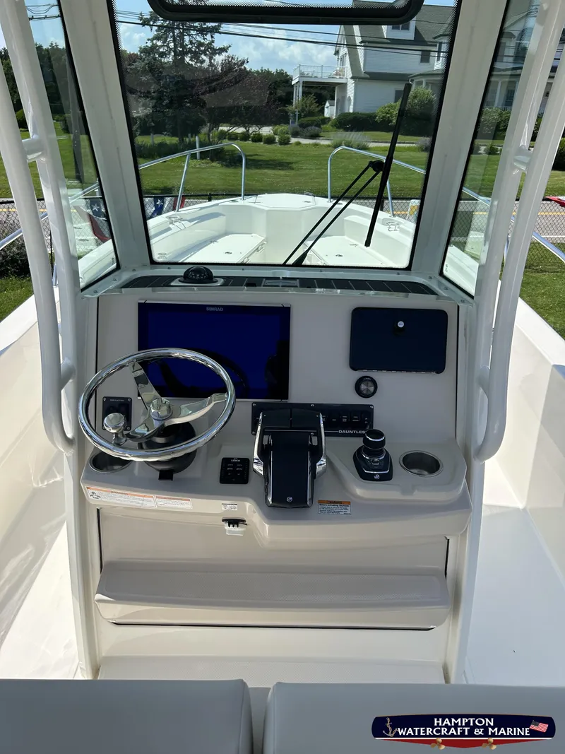 Slide: The Image of 2023 Boston Whaler 280 Dauntless boat console with steering wheel and navigation display. - 16