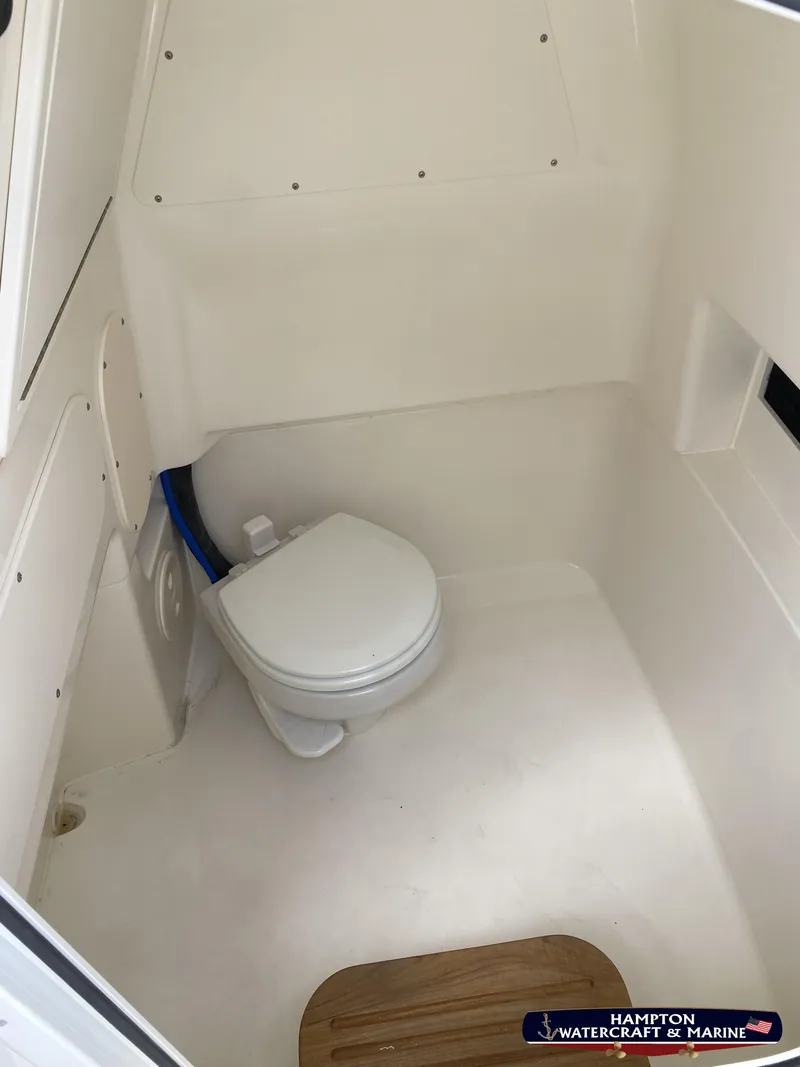 Slide: The Image of 2023 Boston Whaler 280 Dauntless boat interior with compact marine toilet. - 18