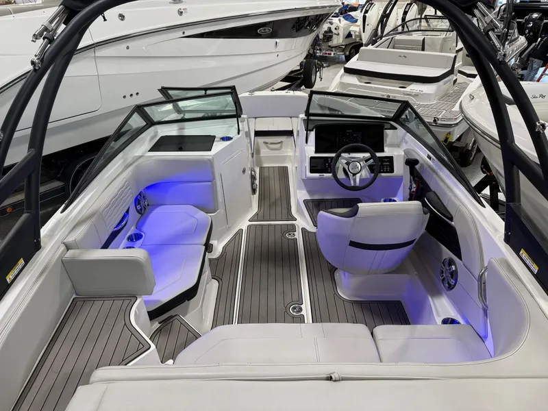 Slide: The Image of 2023 Sea Ray SPX 190 boat interior with modern seating and blue accent lighting. - 14