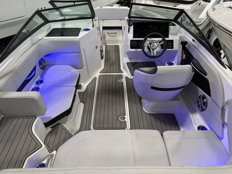 Slide: The Image of 2023 Sea Ray SPX 190 boat interior with modern seating and ambient blue lighting. - 15