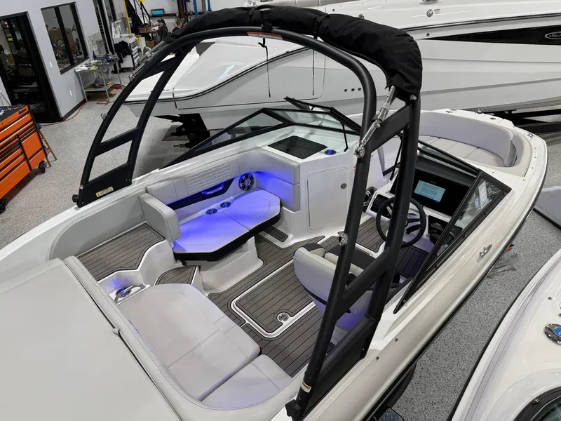 Slide: The Image of 2023 Sea Ray SPX 190 boat interior with modern seating and ambient lighting. - 16