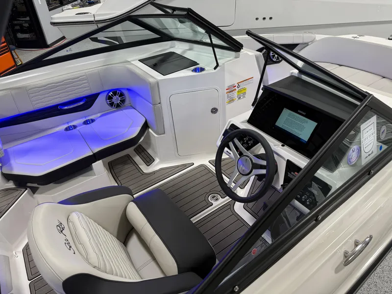 Slide: The Image of 2023 Sea Ray SPX 190 boat interior with modern dashboard and seating. - 17
