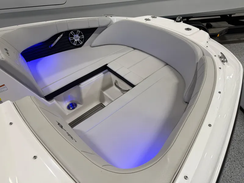 Slide: The Image of 2023 Sea Ray SPX 190 boat interior with blue LED lighting and cushioned seating. - 19