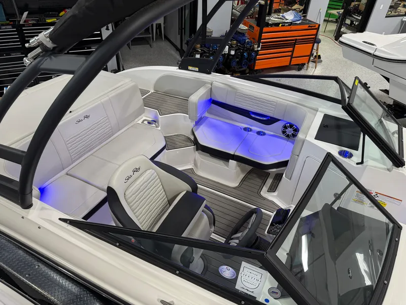 Slide: The Image of 2023 Sea Ray SPX 190 boat interior with modern seating and blue LED lighting. - 21