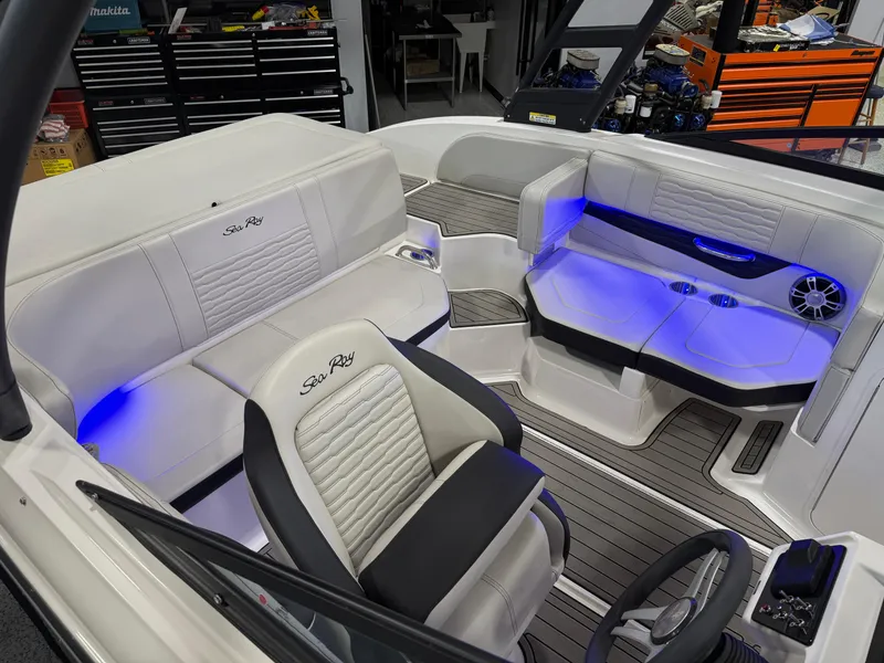 Slide: The Image of 2023 Sea Ray SPX 190 boat interior with blue LED lighting and luxurious seating. - 22